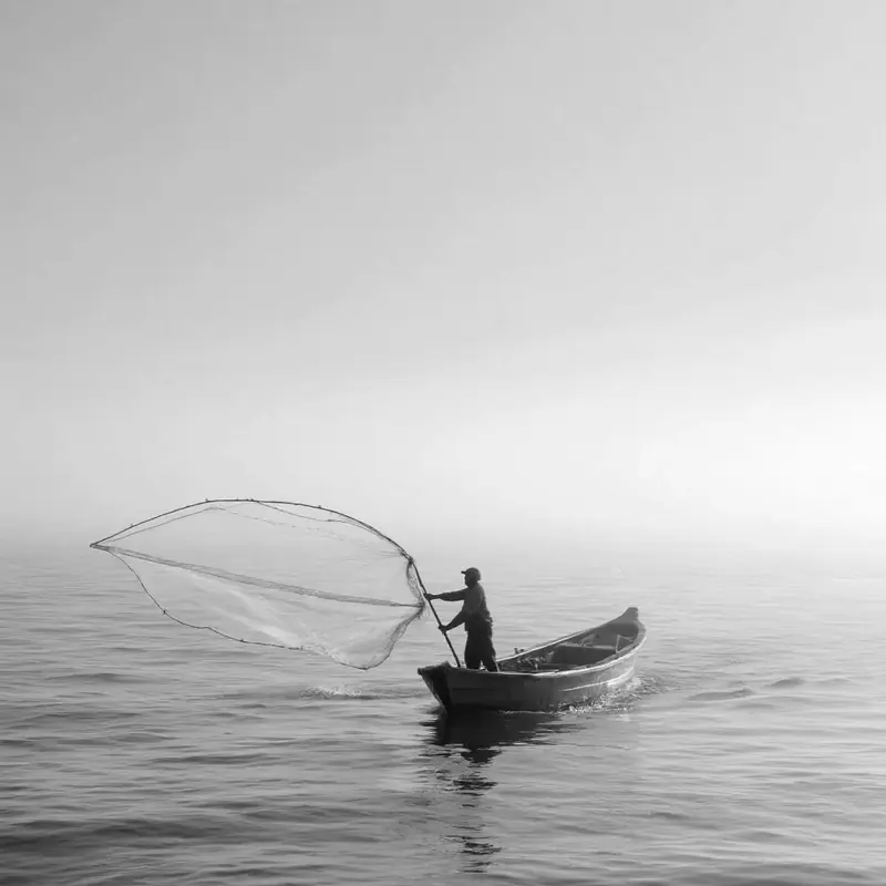 A lone boat casting on flat, open water